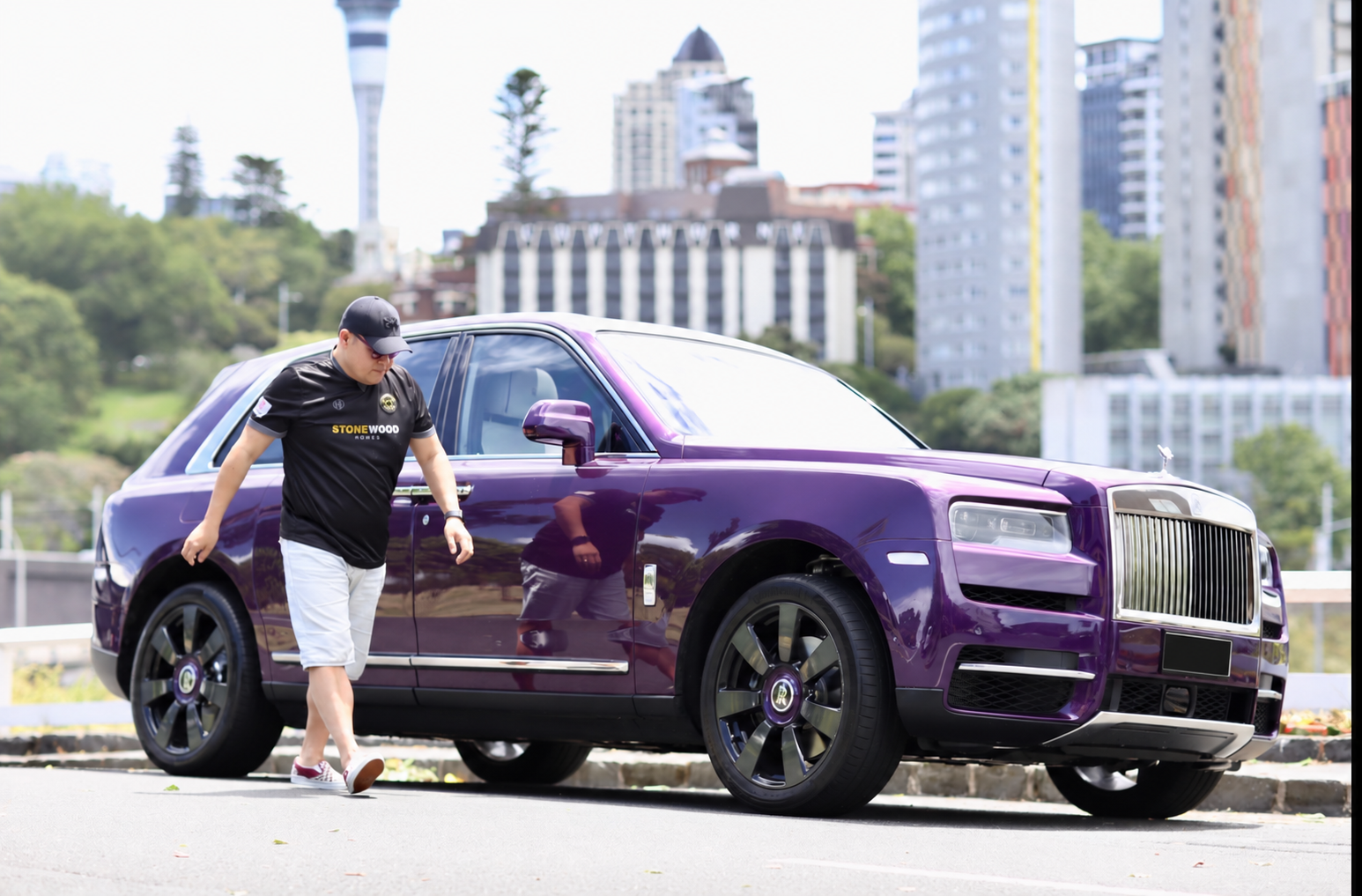 John Chow beside his purple Rolls-Royce